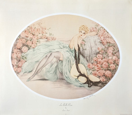 Vintage French art print titled 'La Belle Rose' by Louis Icart, showing an illustration of a woman reclined elegantly amongst a bower of pink roses. She's wearing a flowing, light turquoise dress, with a long black scarf draped around her arms and flowing onto the floor. The print has a warm, pale background and is bordered by a white oval frame within the print, with the artist's signature at the bottom right.